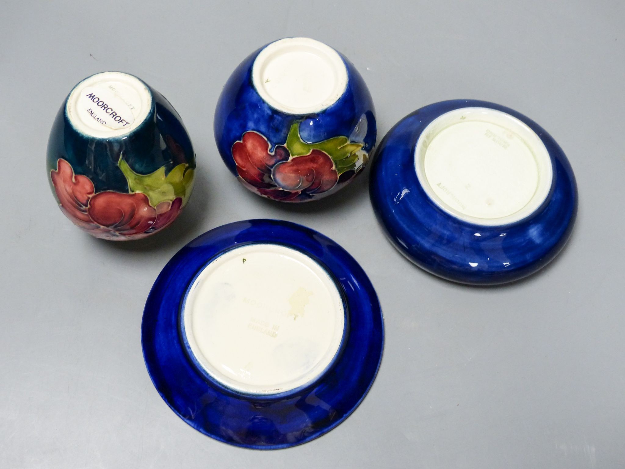 Two Moorcroft Hibiscus pattern vases and a similar dish together with a Moorcroft wisteria pattern dish, 11cm